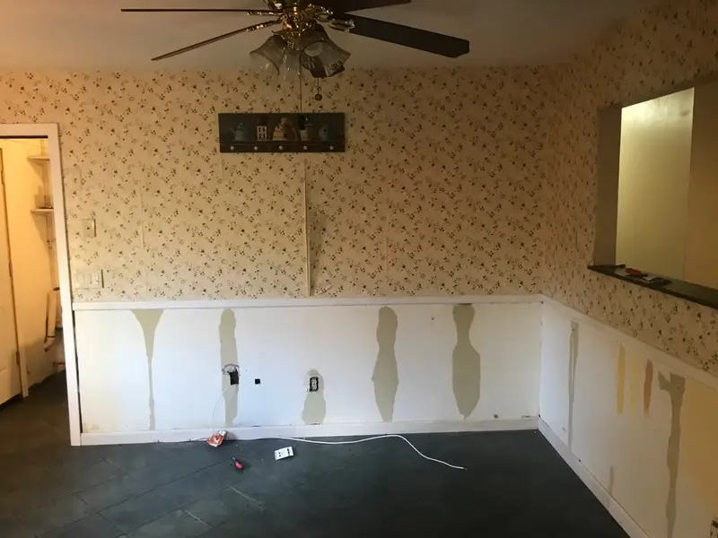 Dining room with patched wainscoting and old wallpaper, Mastic, NY